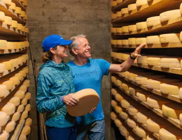 Backroads guests looking at wheels of cheese