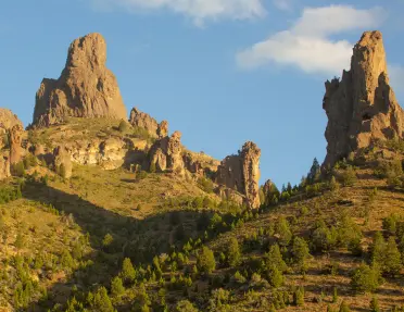 Large canyons and cliffs with a valley of bushes and shrubs