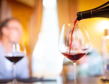 Bottle of wine being poured into a glass