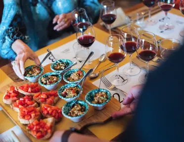 Two people at a table with prepared toast and wine glasses