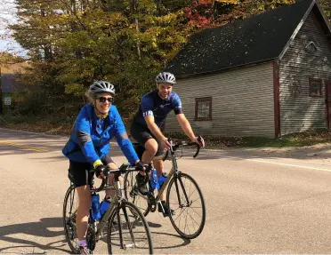 2 guests ride their bikes on the Vermont to the Adirondacks bike tour