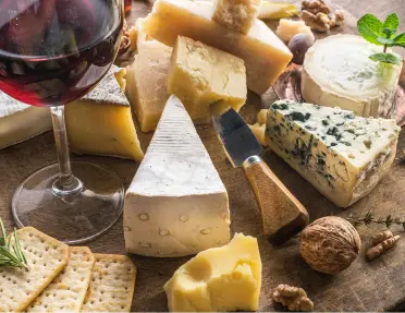 An assortment of cheese with wine and crackers on the Bordeaux & Dordogne Bike Tour