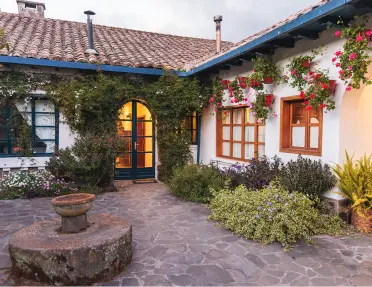 House exterior with cobblestone flooring and large windows