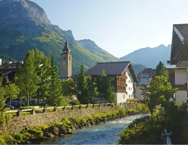 Small town with stone buildings, and a river flowing through a canal