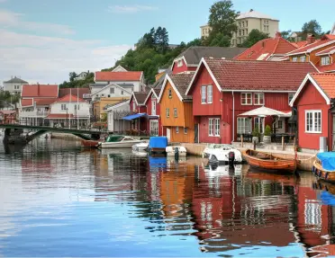 Red buildings and houses along an ocean dock