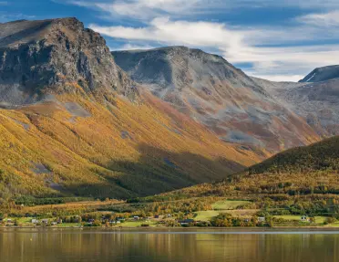 Dramatic mountains reflected in a calm lake in Norway.