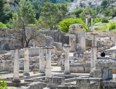 Stone building ruins with trees and bushes in the background