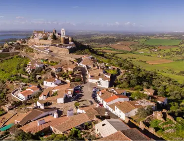 Sky view of a small hill-top town with orange and brown houses