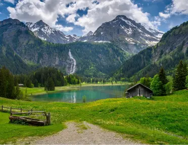 Large valley with a lake in the center, and tall mountains in the distance