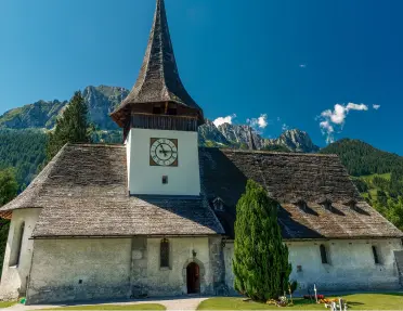 Rustic church with tall trees in the background