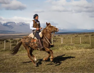 Man riding a horse in an open valley