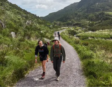 A group of women hiking in Ireland on gravel trail.