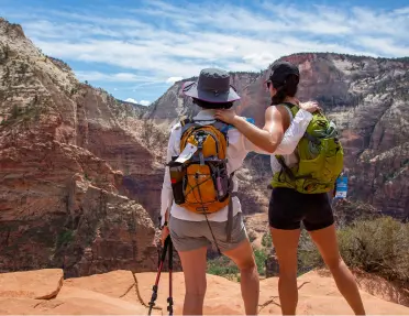 Guests on a hike looking at the view of the mountains in Zion National Park, Utah