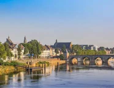 Stone bridge over a river, connected to a small town