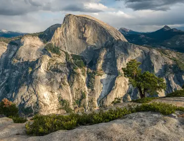A view of Half Dome from the peak of a nearby mountain.