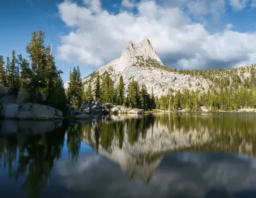 View of a mountain range reflected on a lake.
