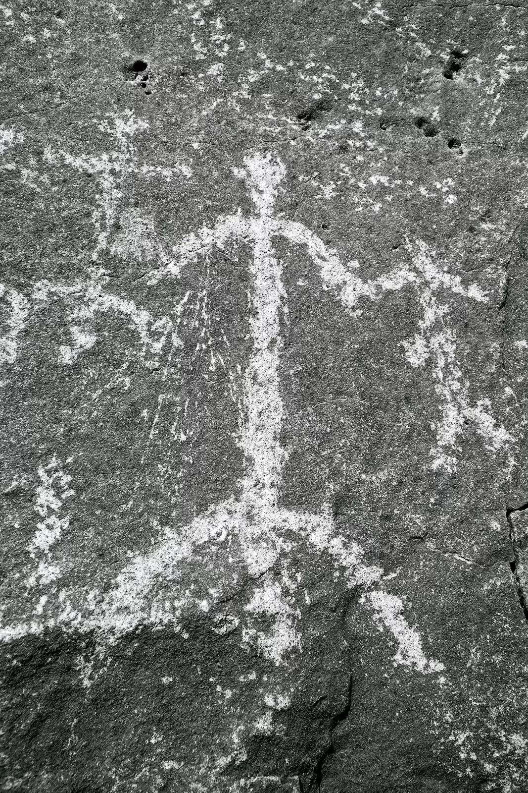 Shot of rock etching, human forms.