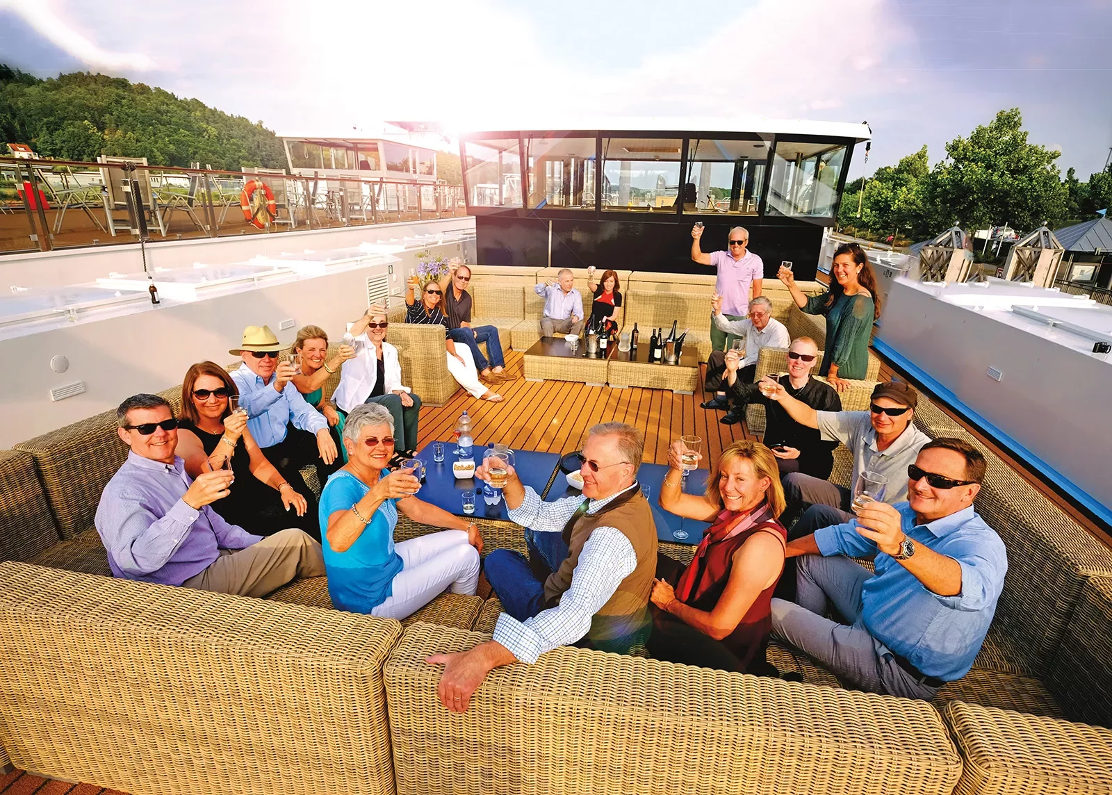 Group of Backroads' guests having happy hour aboard a ship.