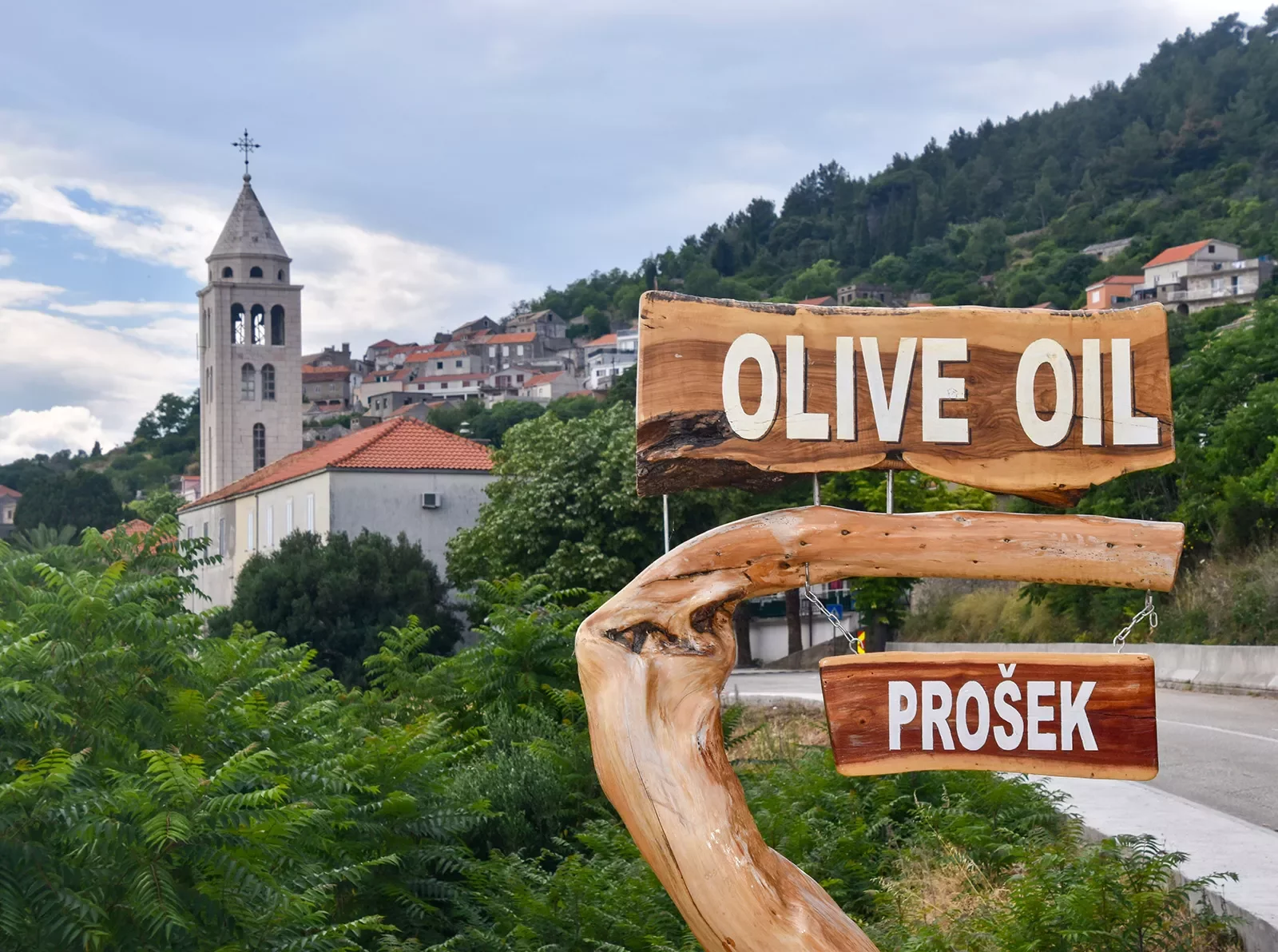 Shot of Croatian hillside town, Prosek, and 'Olive Oil&quot; sign.