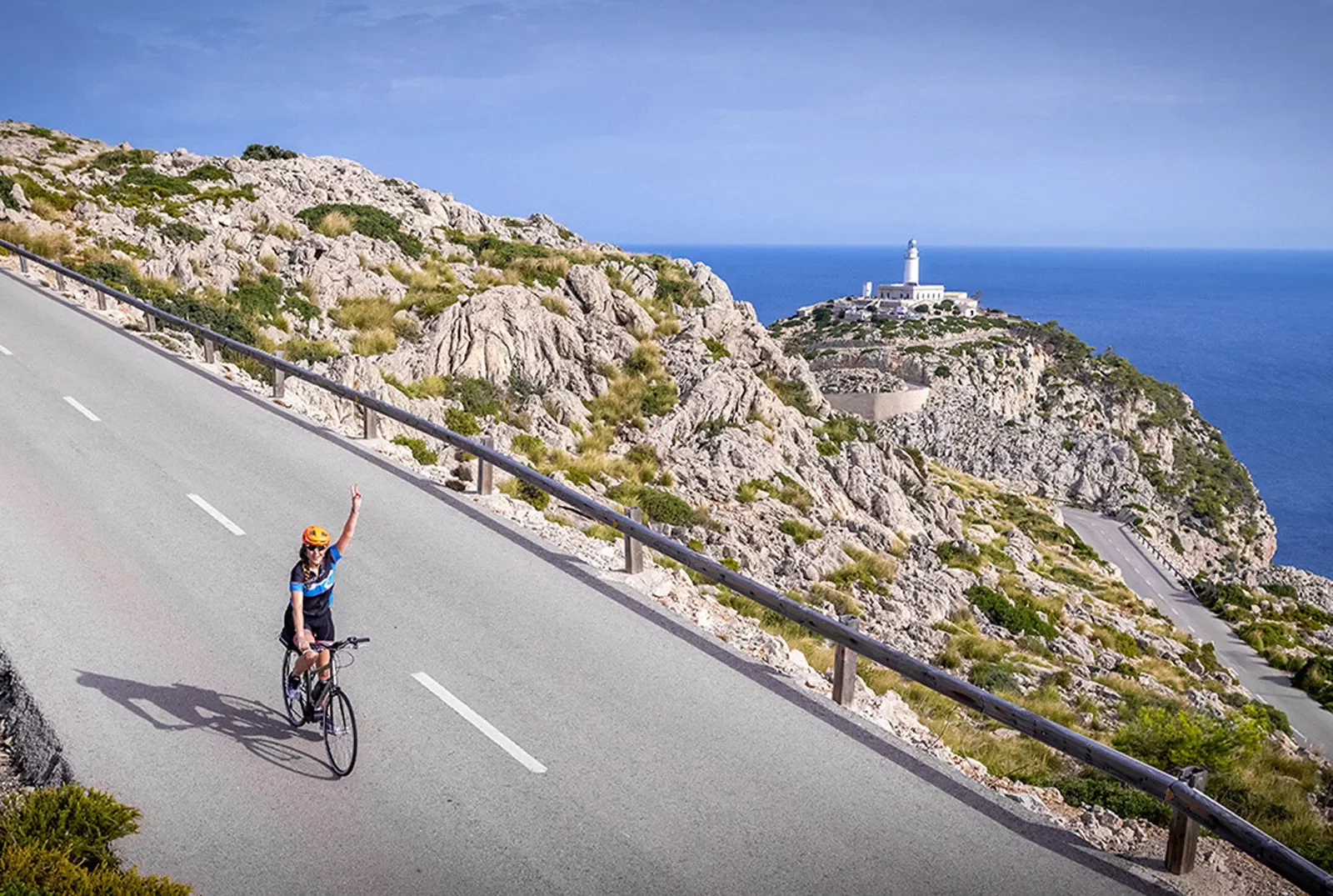 Biker riding on a road on the coast of Mallorca.