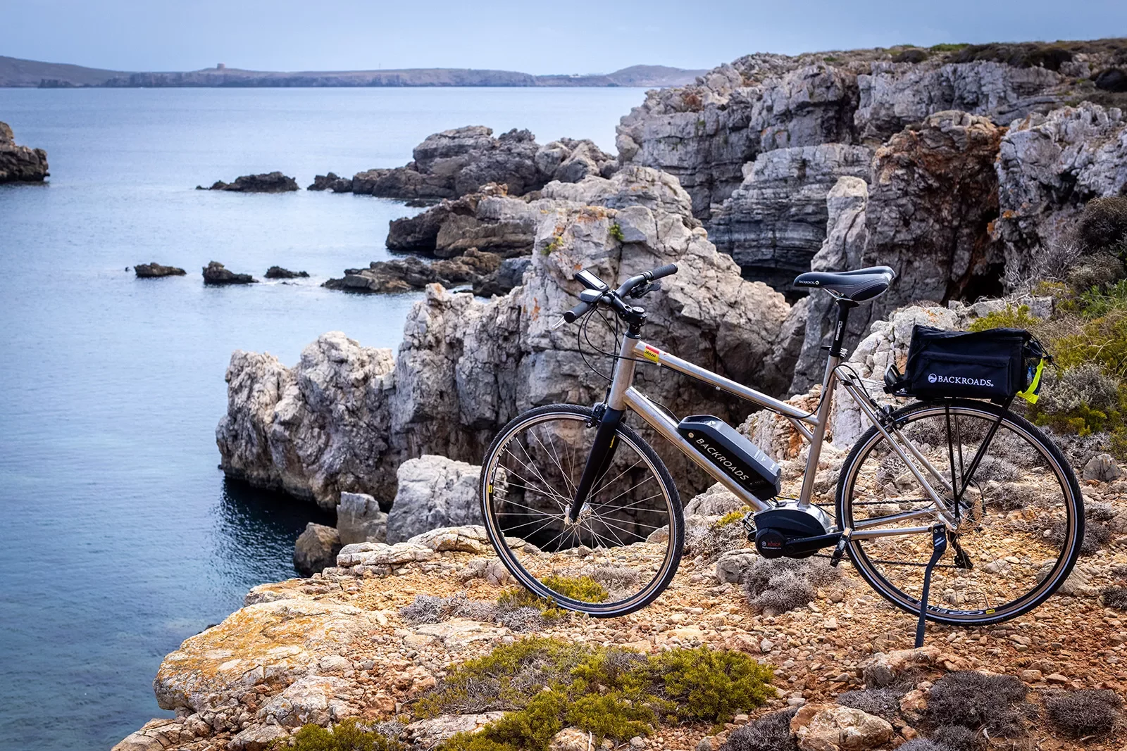 E-bike posed on a rocky cliff .