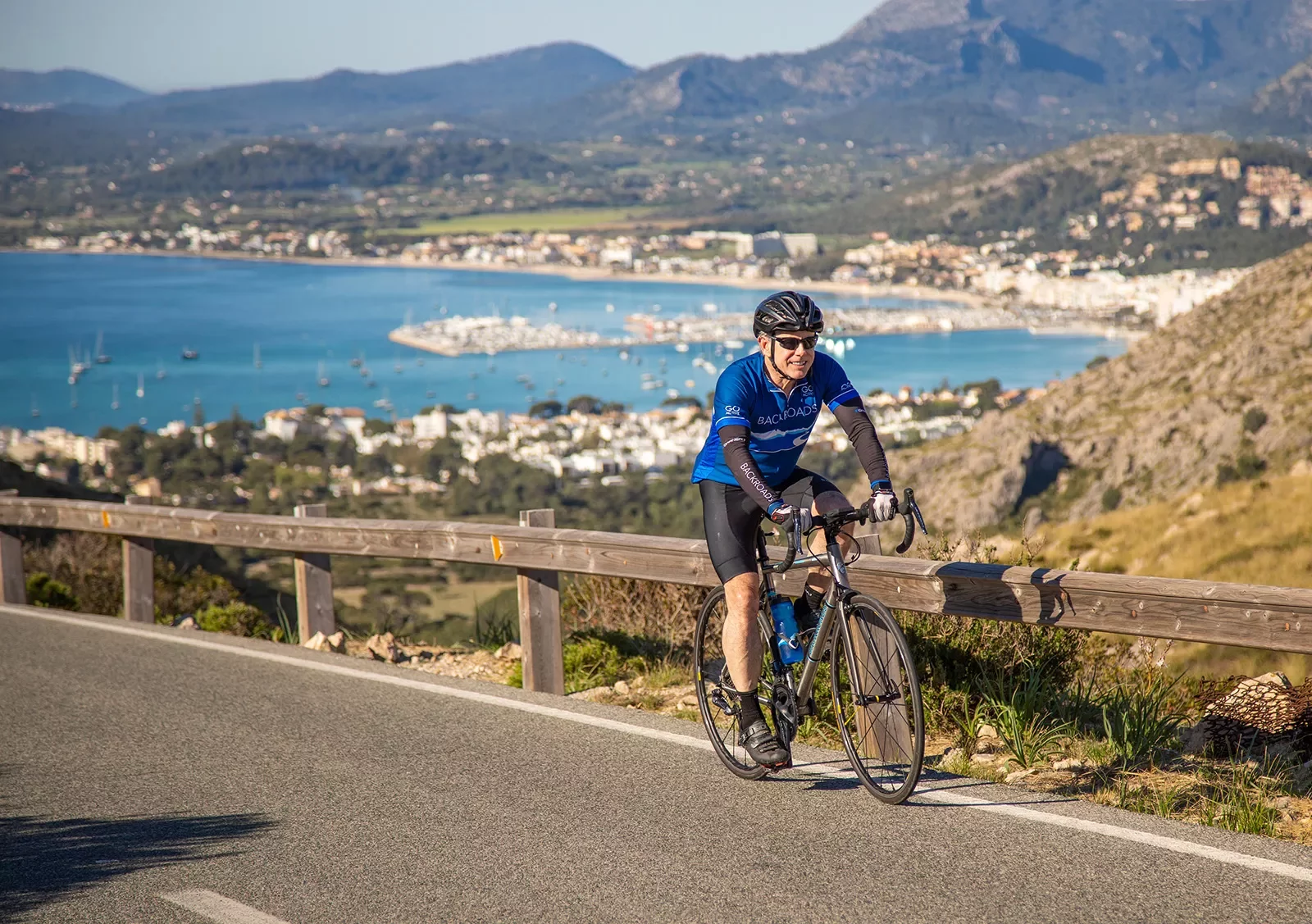 Biker riding along the coast in Menorca.