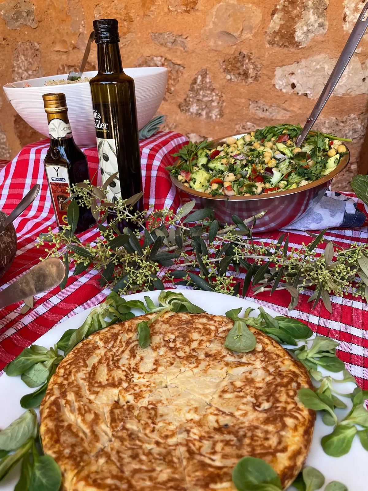 Table with snacks, Spanish tortilla and salad.