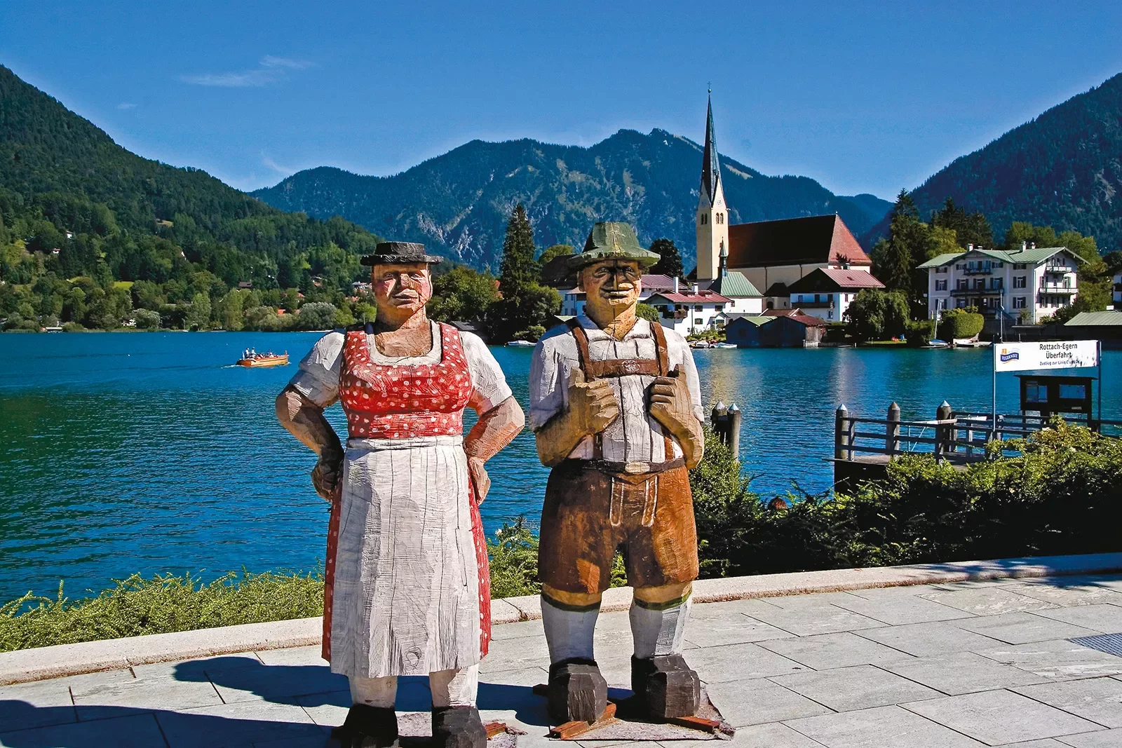 Two chiseled wooden statues in German dress.