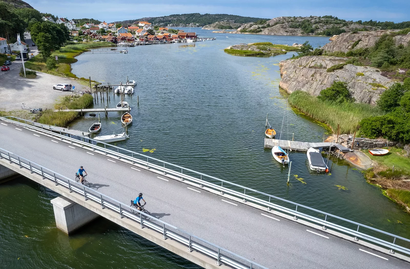 Two bikers riding over a bridge in Norway
