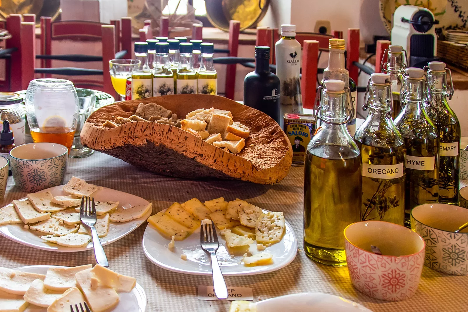 Cheese plates with bottles of olive oil.