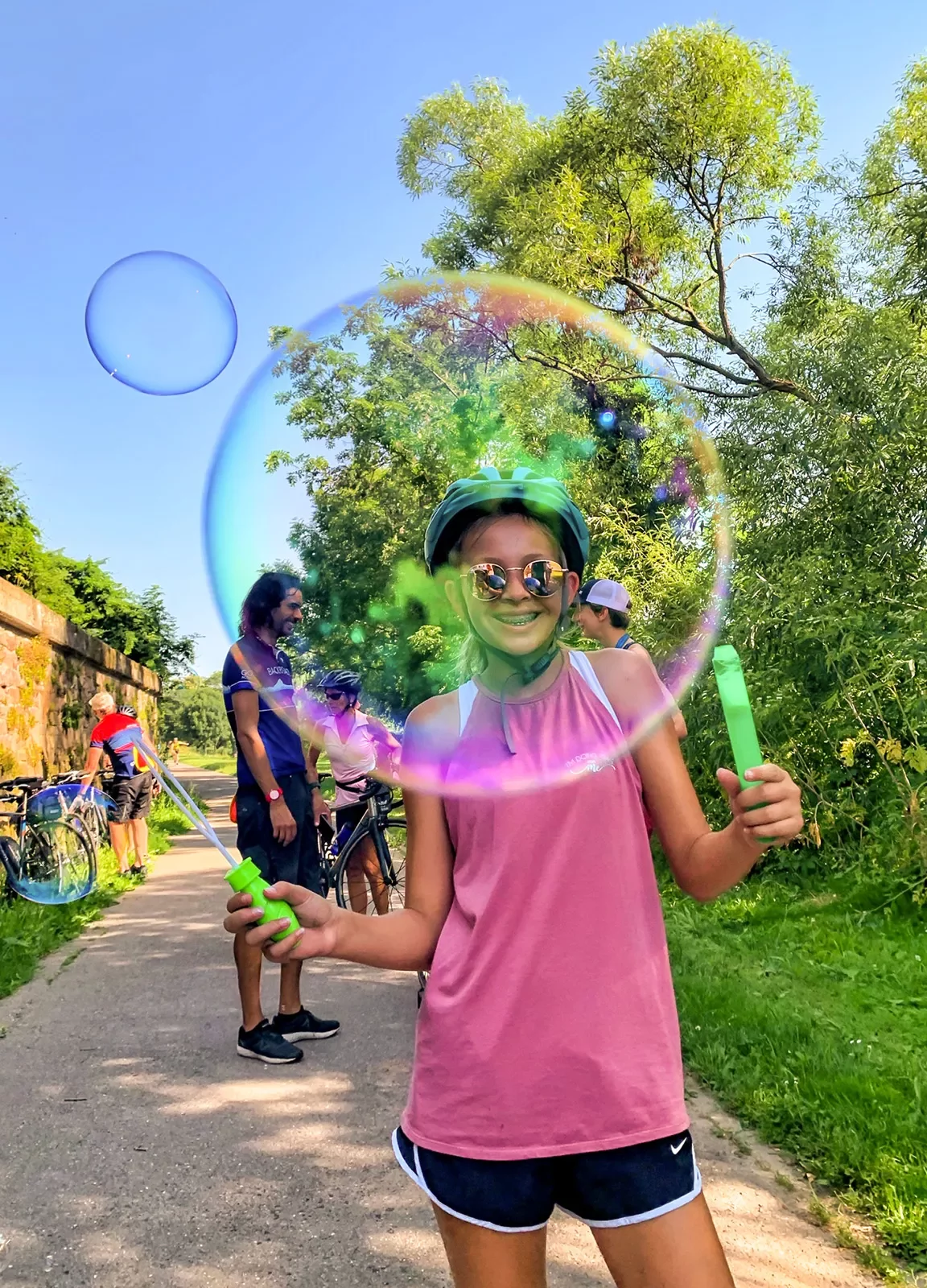 girl blowing a bubble and smiling