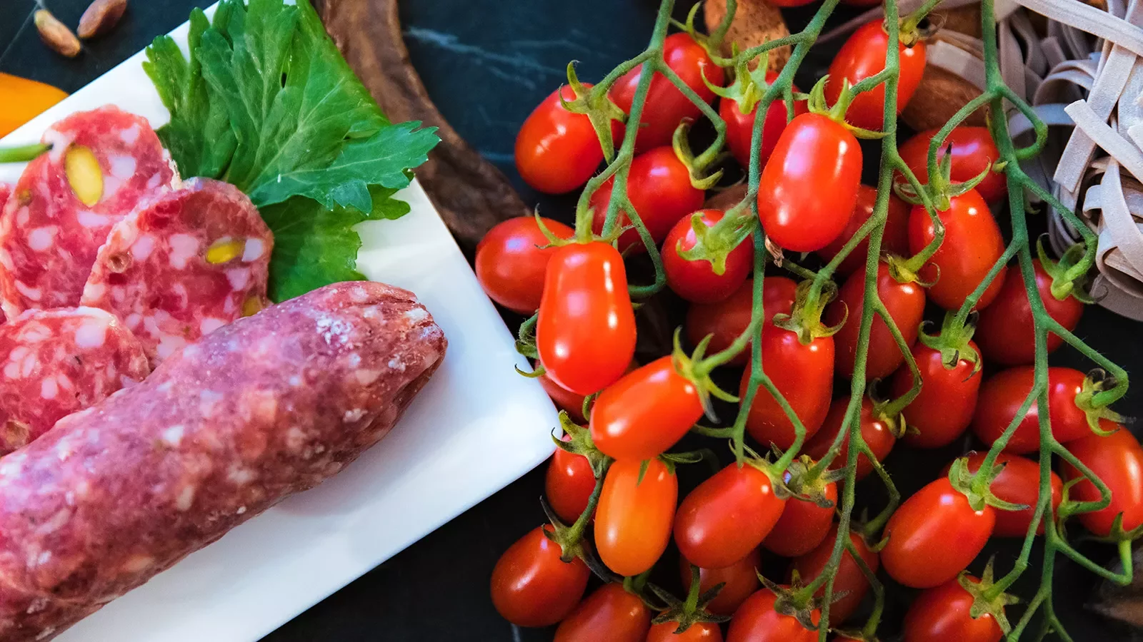 Close-up of cherry tomatoes and salami.