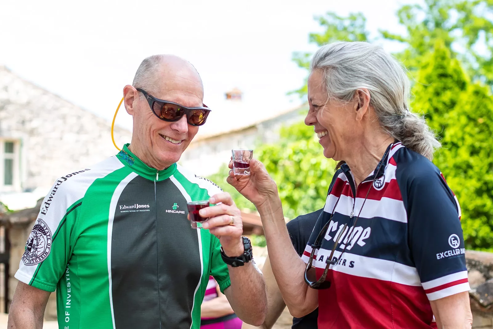 Two guests laughing and chatting in bike jerseys