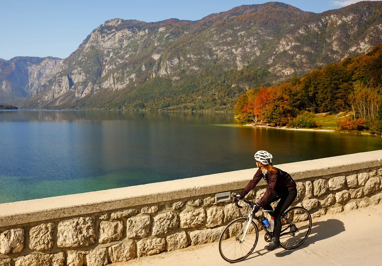 Biker riding along a lake in Slovenia