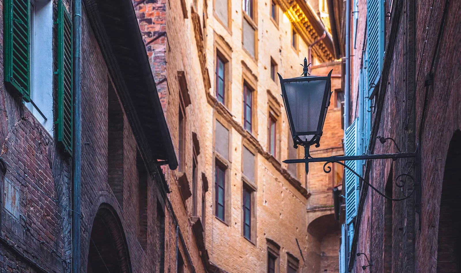 Shot of Italian alleyway, tall buildings, lamp.