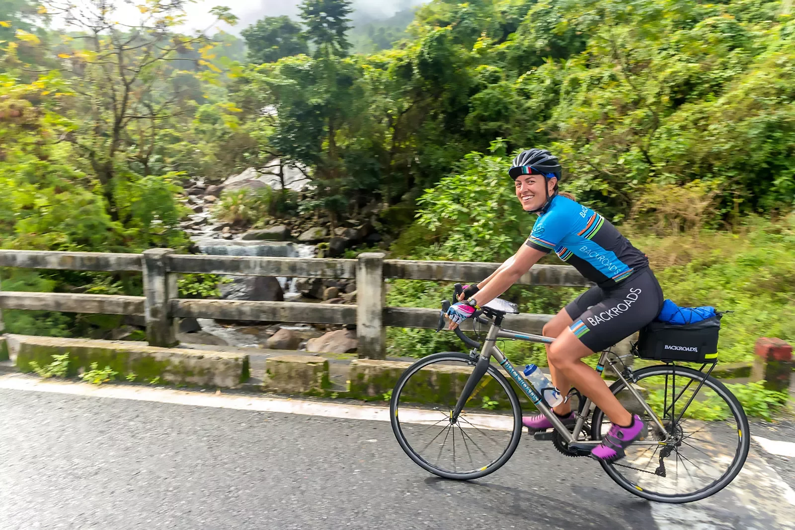 Woman riding along a road in Vietnam