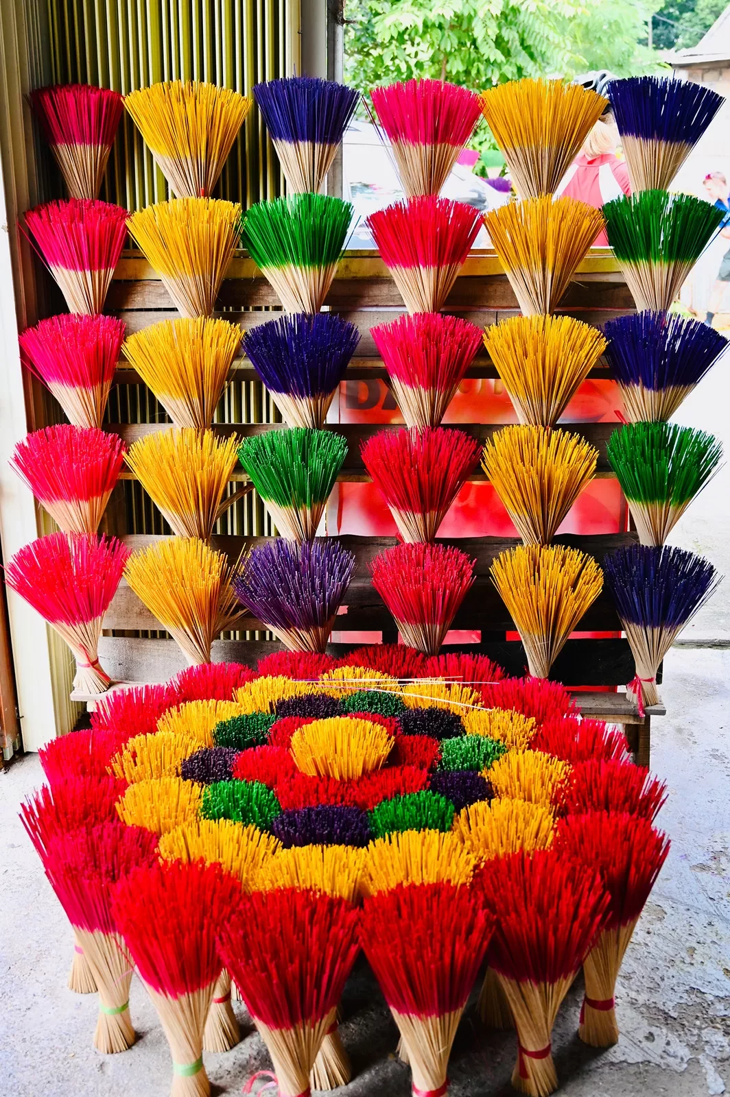 Large array of colorful incense sticks.