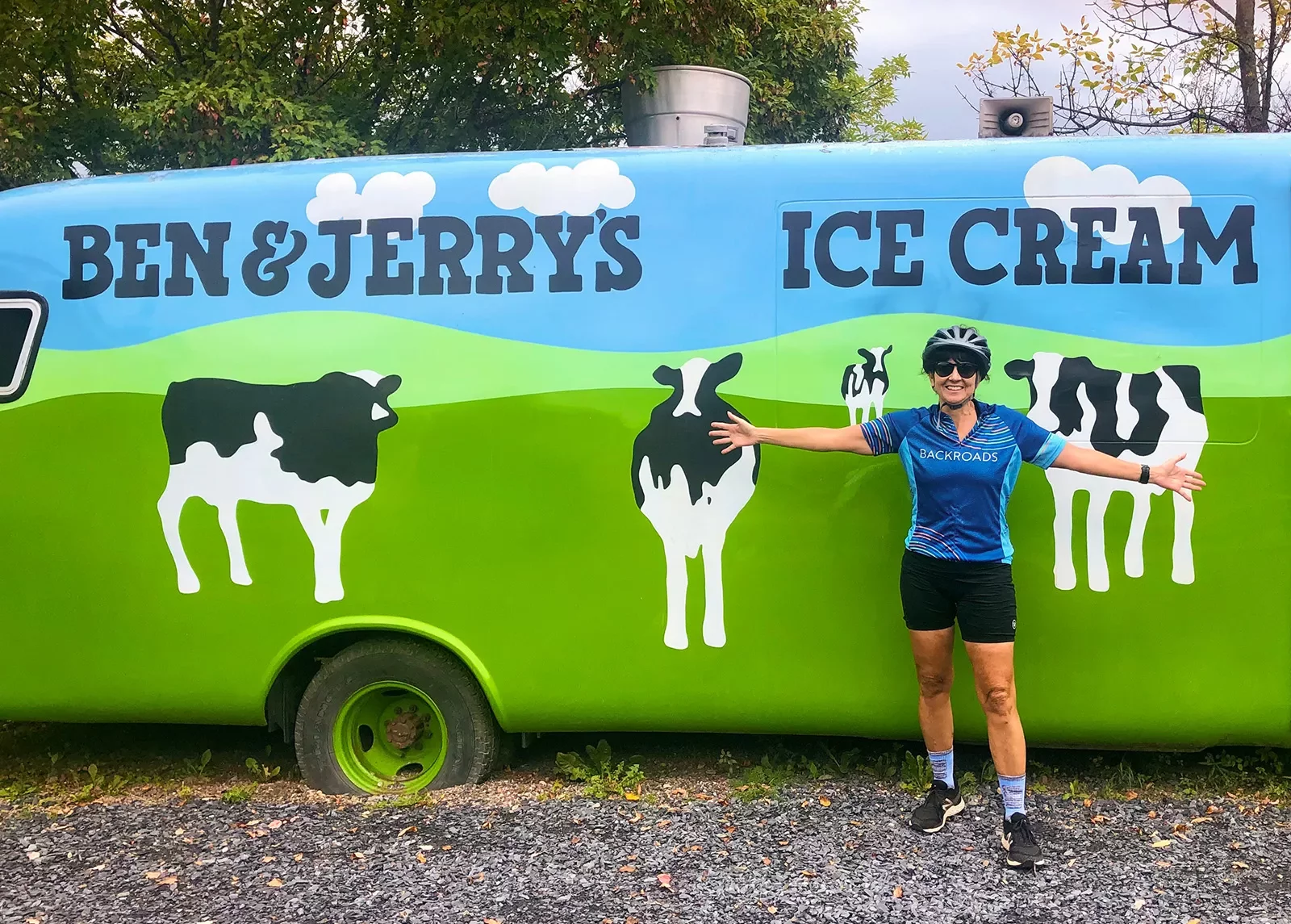 Guest posing in front of Ben &amp; Jerry's car.