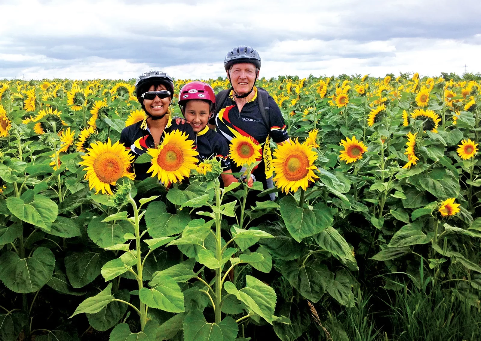 Backroads guests smiling among a field of sunflowers