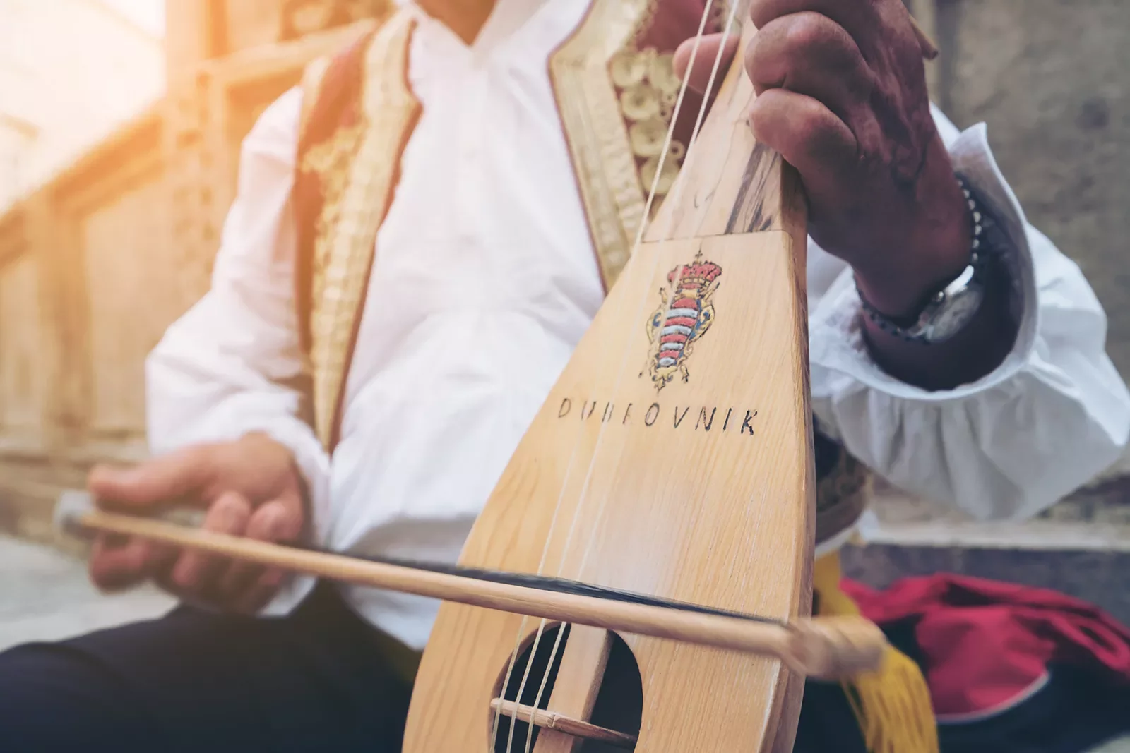 Close-up of local playing string instrument.