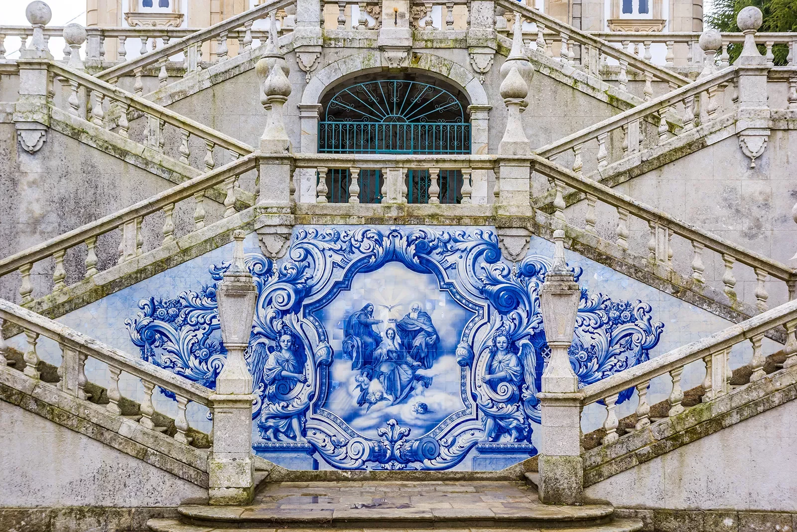 Cathedral stairs, detailed blue mosaic of religious significance below.
