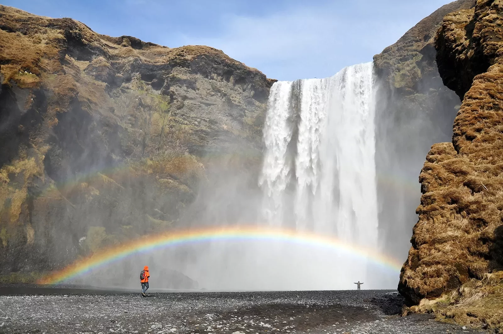 Waterfall with a full rainbow across it