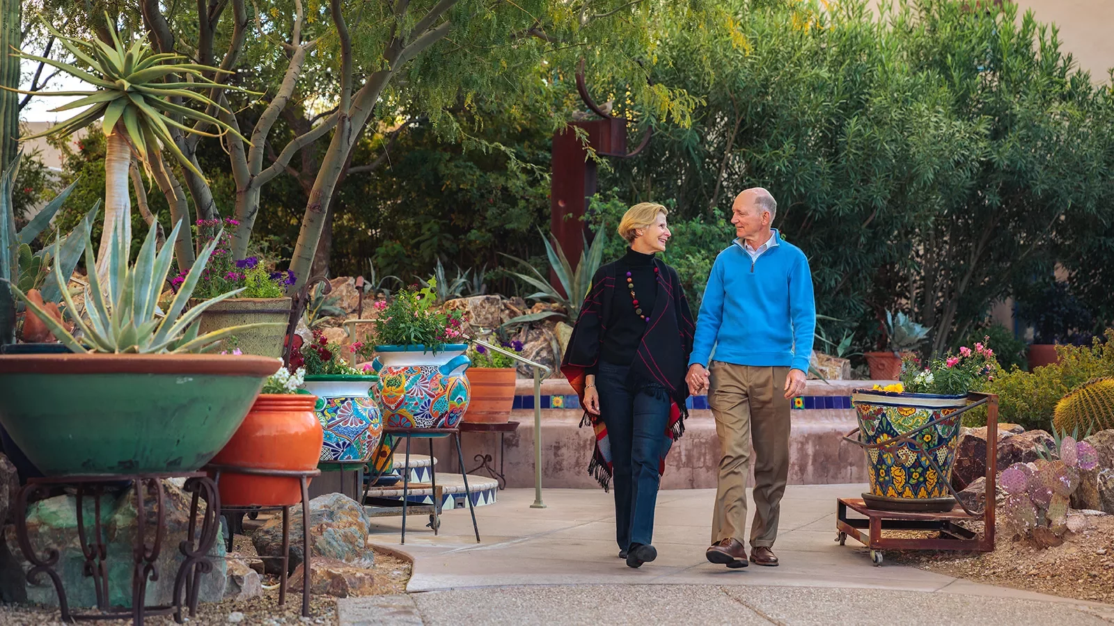 Couple holding hands walking in patio AZ
