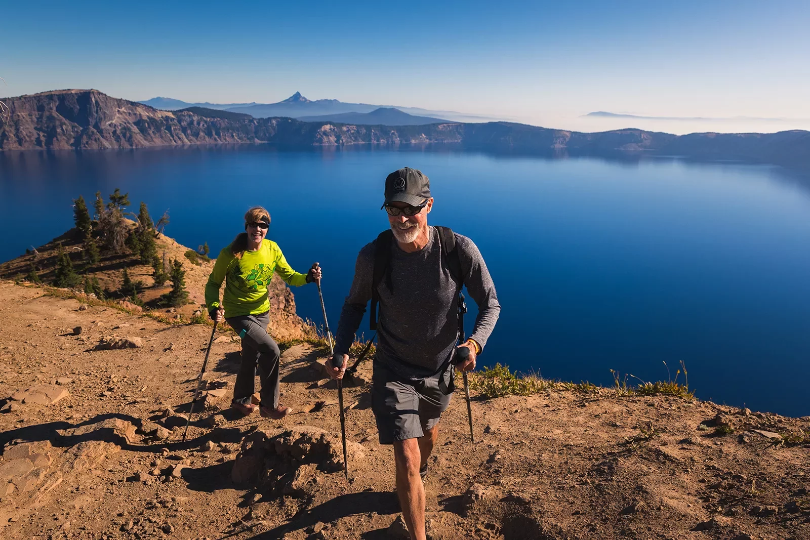 Two guests hiking along the rim of Crater Lake.