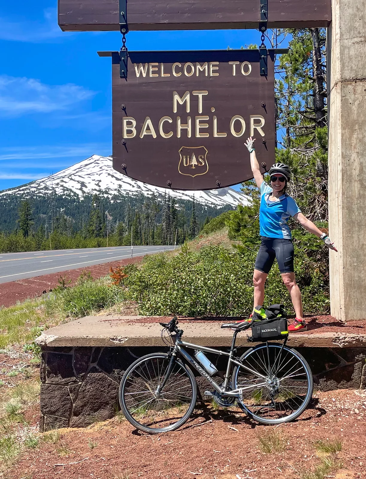 Guest posing with the &quot;WELCOME TO MT. BACHELOR&quot; sign.