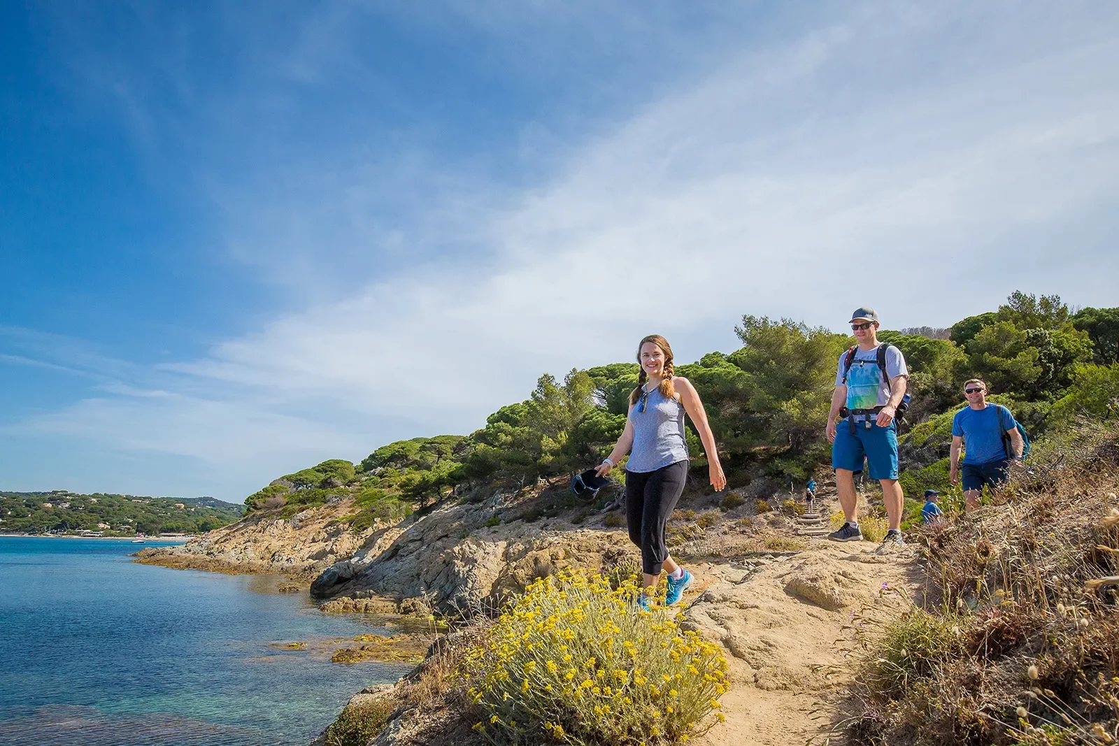 Group of three Backroads guests hiking beside the sea in France