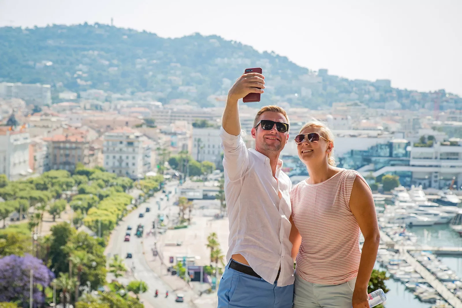 Two Backroads guests taking a selfie in front of a seaside town