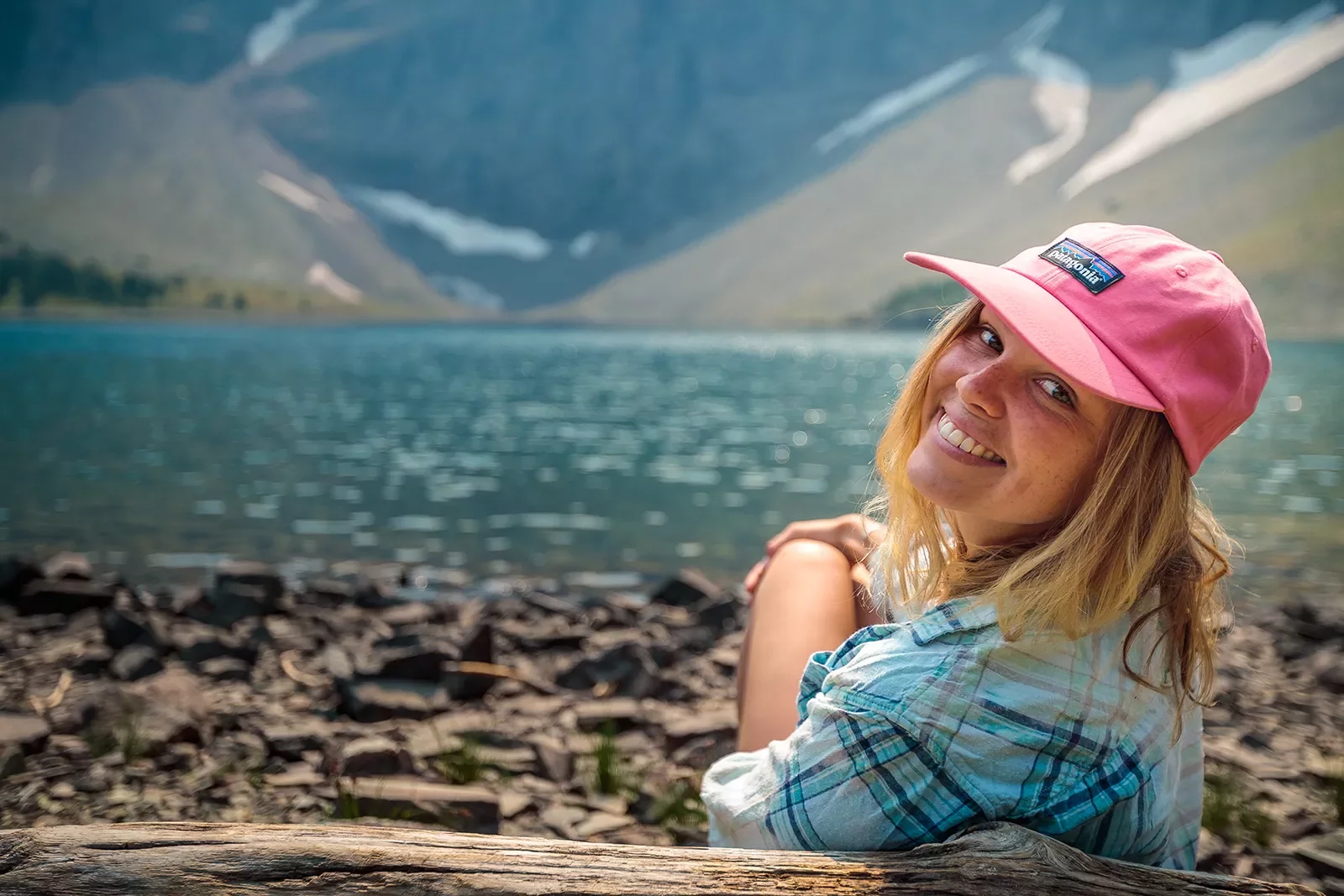 Backroads guest smiling in front of lake and mountains