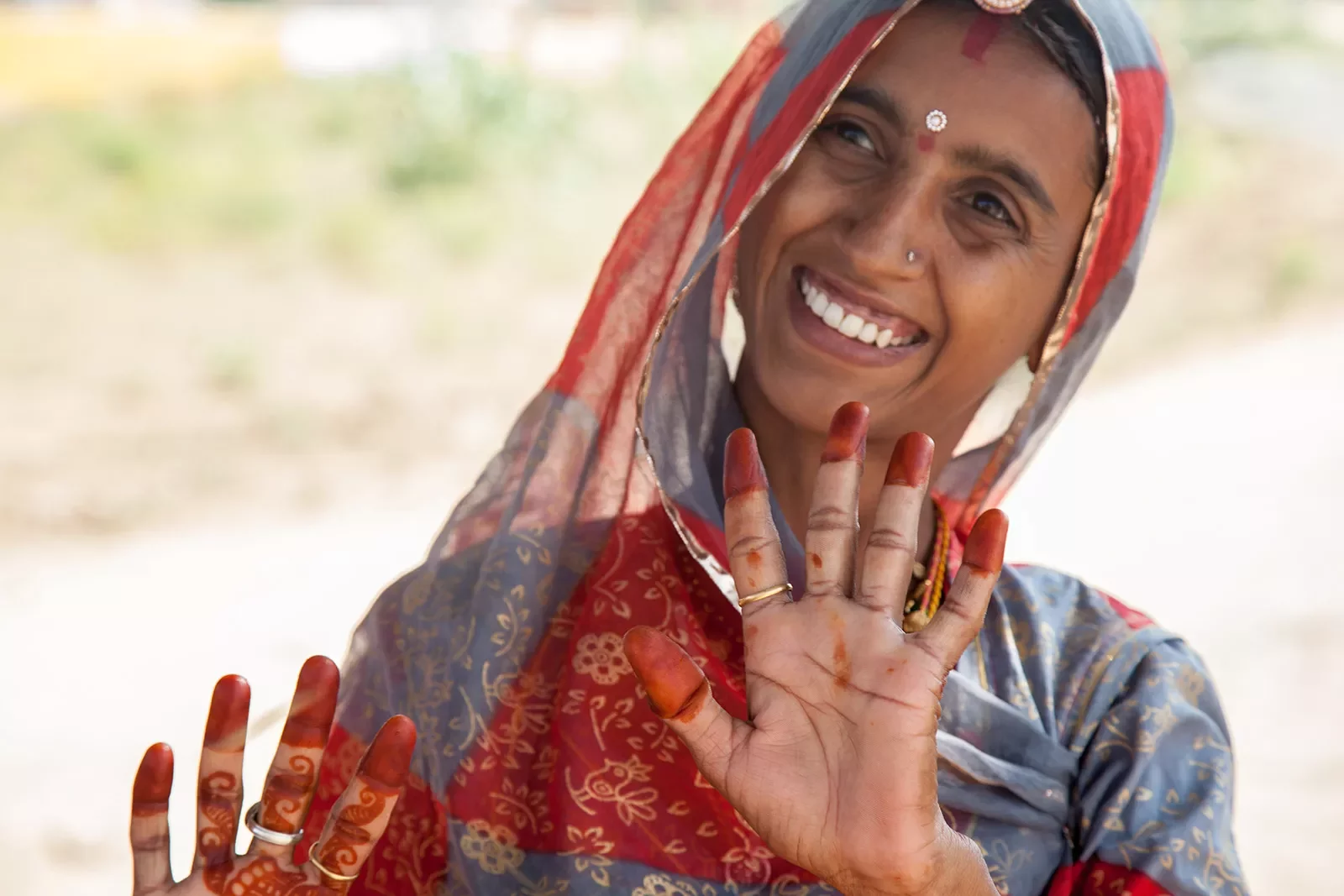 Indian woman showing off her died finger tips