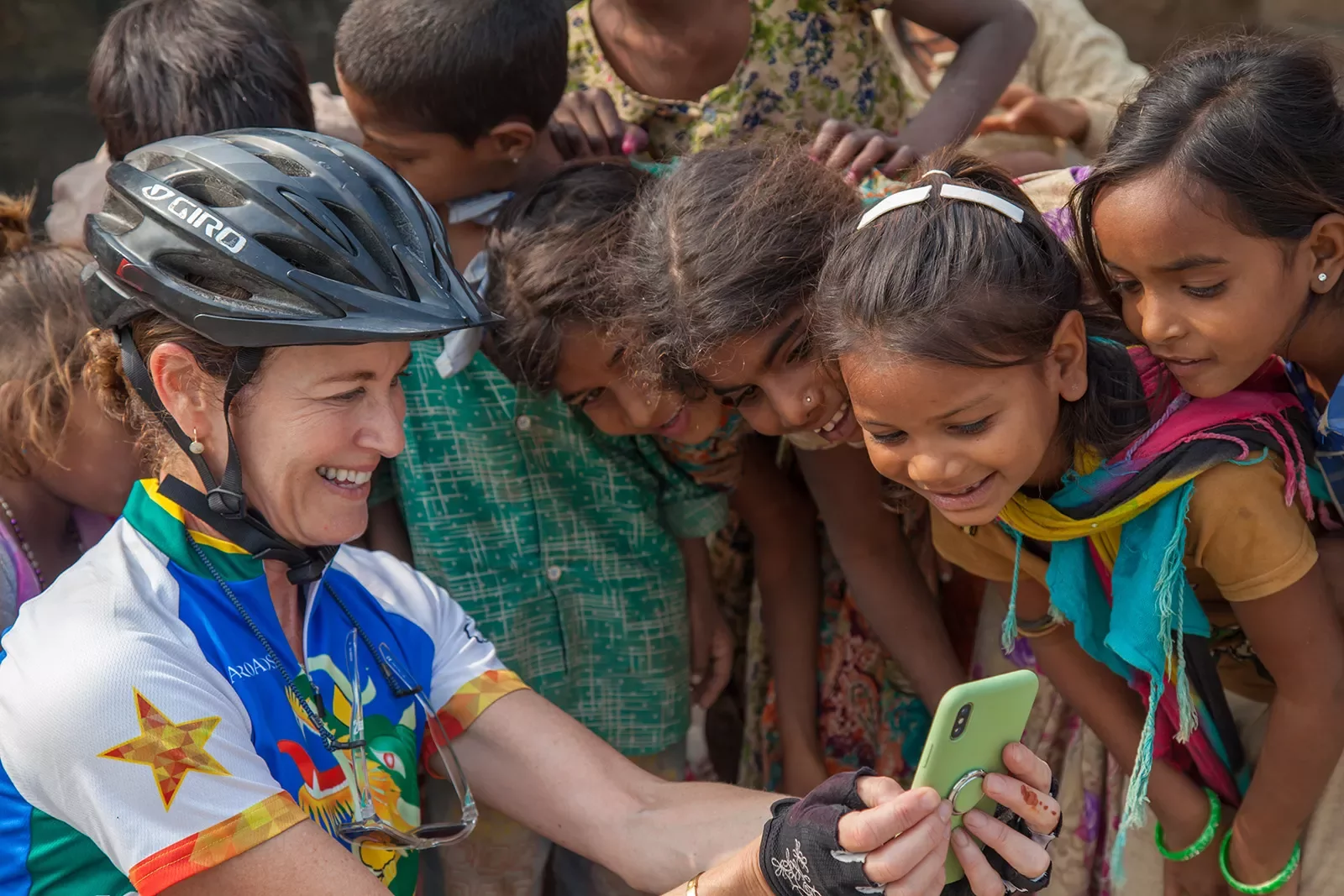 Woman showing her phone to children in India